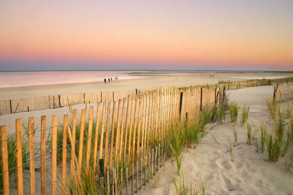 A fence shows a walkway to the beach in Cape Cod, Massachusetts.